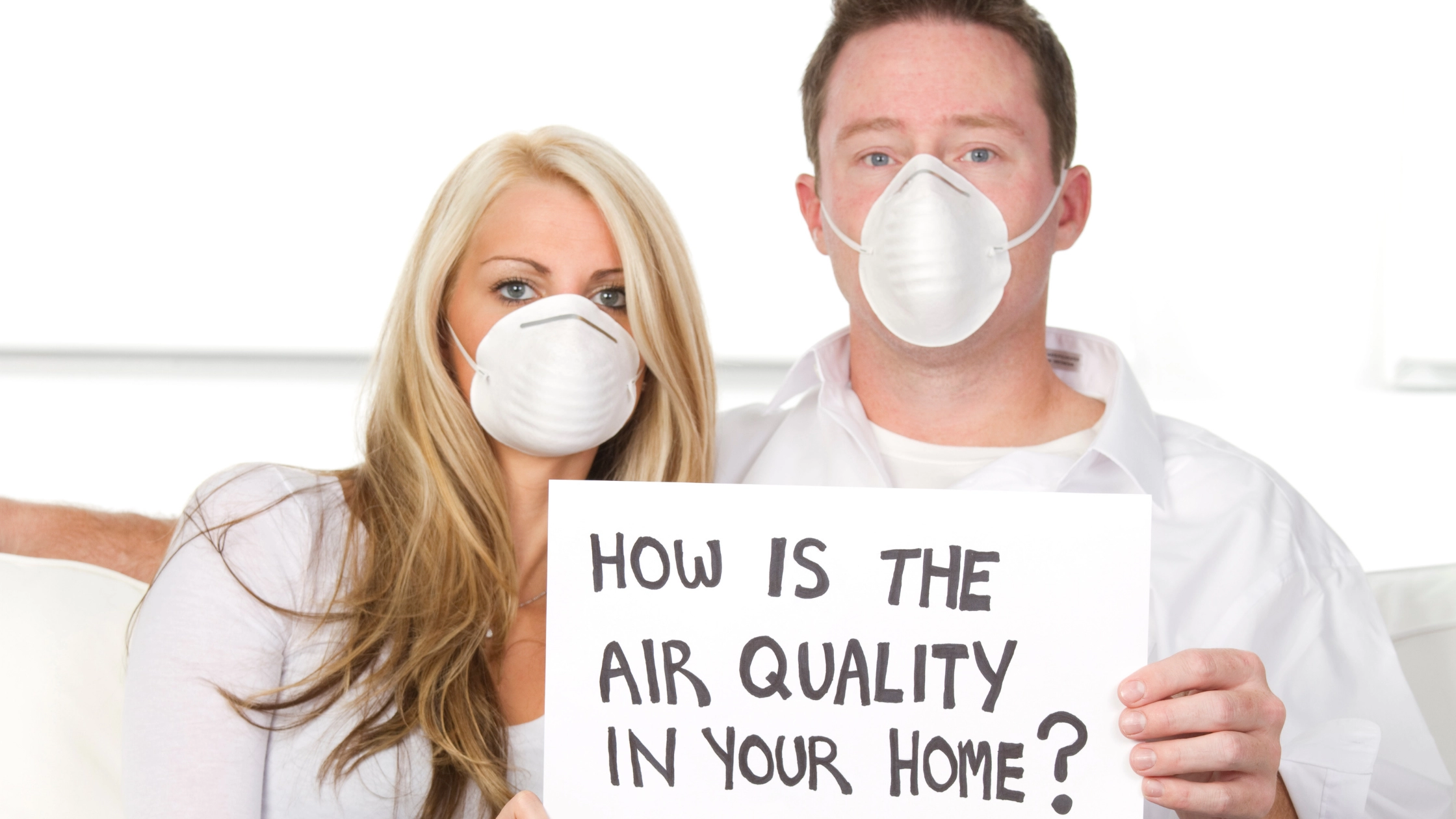 Couple Holding Air Quality Sign